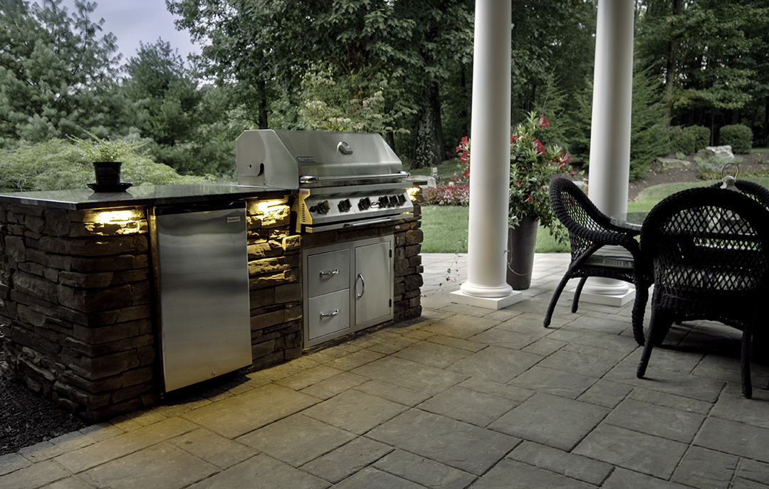 Rustic Stone Fireplace with Custom Outdoor Kitchen designed by Beall's Landscaping