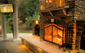 Rustic Stone Fireplace with Custom Outdoor Kitchen designed by Beall's Landscaping